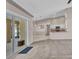 Living room with sliding glass doors leading to screened-in porch and open kitchen concept at 4331 Marcella Ter, North Port, FL 34286