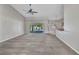 Spacious living room with carpeted floor, sliding glass doors to the pool area, and a ceiling fan at 4331 Marcella Ter, North Port, FL 34286