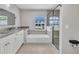 Bathroom featuring double sink vanity, bathtub with shower, and large window at 4331 Marcella Ter, North Port, FL 34286