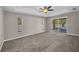 Main bedroom with tray ceiling, neutral walls, carpeted floor, and access to outdoor patio at 4331 Marcella Ter, North Port, FL 34286