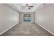 Main bedroom with tray ceiling, carpet, neutral walls, and slider to outdoor living space at 4331 Marcella Ter, North Port, FL 34286