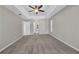 Main bedroom with tray ceiling, neutral walls, carpeted floor, and ensuite bathroom at 4331 Marcella Ter, North Port, FL 34286
