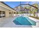 Screened-in pool area and lush backyard surrounded by tropical trees at 4331 Marcella Ter, North Port, FL 34286