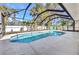 Backyard pool in a screened-in enclosure with lush landscaping at 4331 Marcella Ter, North Port, FL 34286