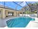 Backyard pool featuring screened enclosure and a tiled pool deck at 4331 Marcella Ter, North Port, FL 34286
