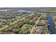 Scenic aerial view of a waterfront community featuring canals and lush greenery at 4420 Larkspur Ct, Port Charlotte, FL 33948