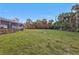 Picturesque backyard featuring sprawling lawn, bird bath and privacy landscaping at 4420 Larkspur Ct, Port Charlotte, FL 33948