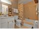 Neutral bathroom featuring tile surround, shower and bathtub with updated fixtures and storage at 4420 Larkspur Ct, Port Charlotte, FL 33948