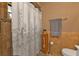 Bathroom features a shower with curtain, a vanity, tile floor, and well-placed fixtures at 4420 Larkspur Ct, Port Charlotte, FL 33948