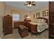 Well decorated bedroom showcasing matching vintage furniture, ceiling fan and plenty of natural light at 4420 Larkspur Ct, Port Charlotte, FL 33948
