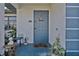 Inviting entryway with blue door, decorative accents, and charming seasonal decorations at 4420 Larkspur Ct, Port Charlotte, FL 33948