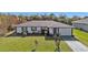 Charming single-story home featuring a well-manicured lawn and a quaint, inviting exterior at 4420 Larkspur Ct, Port Charlotte, FL 33948