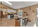 Kitchen area with stainless steel appliances, white cabinets, tile floors, and breakfast bar with seating at 4420 Larkspur Ct, Port Charlotte, FL 33948