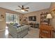 Cozy living room with ceiling fan, sliding glass doors to lanai, and comfortable seating at 4420 Larkspur Ct, Port Charlotte, FL 33948