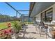 Spacious screened patio, with tiled floors and bar seating overlooking the manicured yard at 4420 Larkspur Ct, Port Charlotte, FL 33948