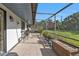 Large screened patio with tile flooring, outdoor seating, and access to a landscaped yard at 4420 Larkspur Ct, Port Charlotte, FL 33948