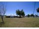 Expansive backyard with mature trees and a well-maintained lawn offers ample space for outdoor activities and relaxation at 458 Azalea Nw Ave, Port Charlotte, FL 33952