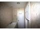 Bathroom with floral wallpaper, built in cabinets, and white fixtures at 458 Azalea Nw Ave, Port Charlotte, FL 33952