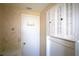 Bathroom with floral wallpaper, built in cabinets, and white fixtures at 458 Azalea Nw Ave, Port Charlotte, FL 33952