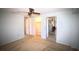 Spacious bedroom features carpet, ceiling fan, closet and access to a bathroom at 458 Azalea Nw Ave, Port Charlotte, FL 33952