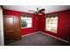 Inviting bedroom featuring red walls, two windows, a ceiling fan, and a closet at 458 Azalea Nw Ave, Port Charlotte, FL 33952
