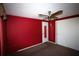 This bedroom features red walls, two closets, and a ceiling fan at 458 Azalea Nw Ave, Port Charlotte, FL 33952