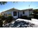 Exterior of home with a concrete patio, neutral paint, and mature plantings at 458 Azalea Nw Ave, Port Charlotte, FL 33952
