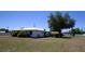 Property features a large, grassy yard, is enhanced by mature trees, and provides plenty of room for outdoor activities at 458 Azalea Nw Ave, Port Charlotte, FL 33952