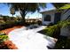 Charming home exterior featuring a concrete patio and lush landscaping at 458 Azalea Nw Ave, Port Charlotte, FL 33952