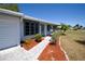 Charming home with a manicured lawn, gray trim, and a brick walkway leading to the front door at 458 Azalea Nw Ave, Port Charlotte, FL 33952
