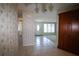 Inviting hallway featuring tile flooring, leading to a well-lit living area and bathroom at 458 Azalea Nw Ave, Port Charlotte, FL 33952