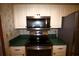 Kitchen featuring stainless steel appliances, white cabinets and green countertops at 458 Azalea Nw Ave, Port Charlotte, FL 33952