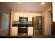 Kitchen featuring modern stainless steel appliances, white cabinets and green countertops at 458 Azalea Nw Ave, Port Charlotte, FL 33952