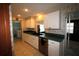 Classic kitchen features tile flooring, white cabinets, and green countertops with sink at 458 Azalea Nw Ave, Port Charlotte, FL 33952