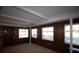 Wood paneled sunroom with large windows and white beamed ceiling at 458 Azalea Nw Ave, Port Charlotte, FL 33952