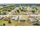 Aerial view of a single-Gathering home featuring a screened lanai, pool, well maintained landscaping, and neighborhood at 474 Rio De Janeiro Ave, Punta Gorda, FL 33983