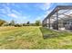 Expansive backyard featuring a screened lanai, pool and plenty of room for outdoor activities at 474 Rio De Janeiro Ave, Punta Gorda, FL 33983