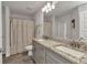 Bathroom with double vanity, granite countertop, and decorative shower curtain at 474 Rio De Janeiro Ave, Punta Gorda, FL 33983