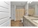 Bright bathroom featuring a granite countertop and decorative shower curtain at 474 Rio De Janeiro Ave, Punta Gorda, FL 33983