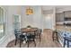 Bright dining area showcasing a round table with chairs, natural light, and modern light fixture at 474 Rio De Janeiro Ave, Punta Gorda, FL 33983
