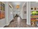 Bright entryway with wood-look tile flooring, elegant lighting fixture, and neutral color palette at 474 Rio De Janeiro Ave, Punta Gorda, FL 33983