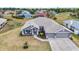 An aerial view showcasing a beautiful home with a three car garage, manicured landscaping, and a welcoming entrance at 474 Rio De Janeiro Ave, Punta Gorda, FL 33983