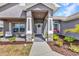 Welcoming front entrance featuring stone accents, lush landscaping, and a charming front door at 474 Rio De Janeiro Ave, Punta Gorda, FL 33983