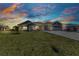 Beautiful single-story home featuring a three-car garage, well-manicured lawn, and inviting landscaping at 474 Rio De Janeiro Ave, Punta Gorda, FL 33983