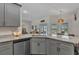 Kitchen showcasing granite countertops, stainless steel appliances, and a view into the living room at 474 Rio De Janeiro Ave, Punta Gorda, FL 33983