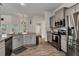 Modern kitchen featuring stainless steel appliances, gray cabinets and access to the back patio and a full bathroom at 474 Rio De Janeiro Ave, Punta Gorda, FL 33983