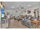 Spacious living room featuring wood-look tile, large sectional sofa, and view of the outdoor area at 474 Rio De Janeiro Ave, Punta Gorda, FL 33983