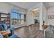 Open-concept living room with wood-look floors, large window, and neutral decor at 474 Rio De Janeiro Ave, Punta Gorda, FL 33983