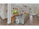 Open living room featuring wood-look tile flooring, a ceiling fan, and a comfortable sofa at 474 Rio De Janeiro Ave, Punta Gorda, FL 33983
