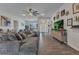Spacious living room with modern ceiling fan, wood-look tile flooring, and comfortable, over-sized sectional sofa at 474 Rio De Janeiro Ave, Punta Gorda, FL 33983